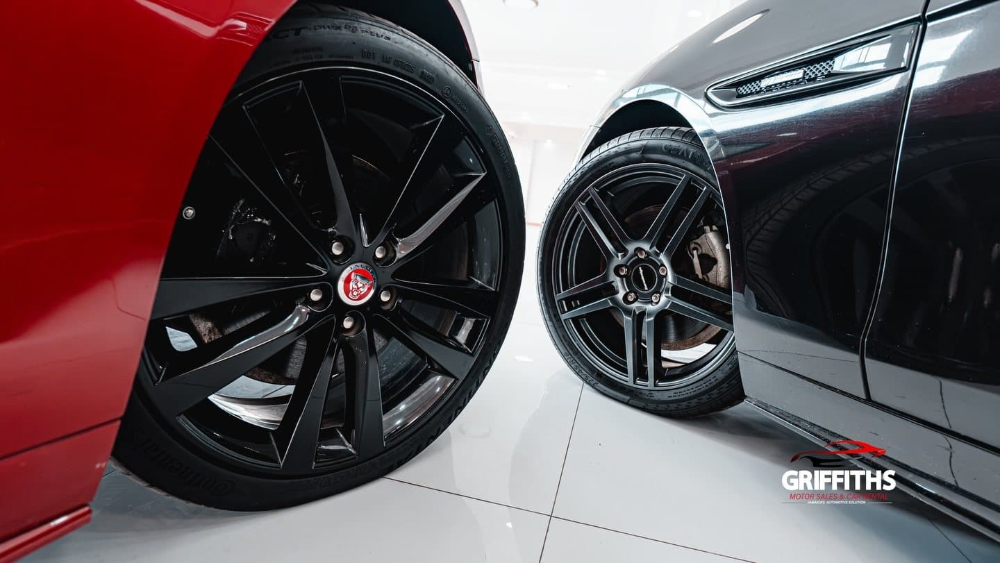 Wheels of two cars on the Griffiths Motor Sales showroom floor